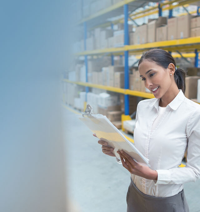 Warehouse management employee checking inventory