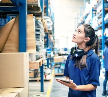 Lady checking the stock in the warehouse