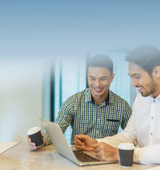 Two men working in front of the laptop