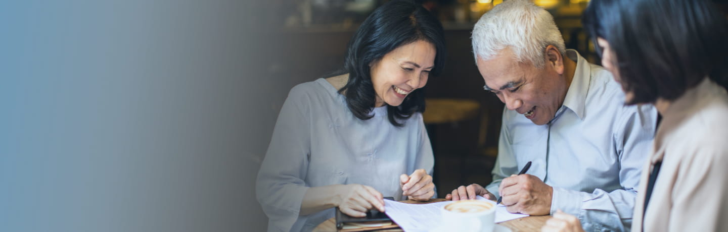 old asian guy is writing his will with wife