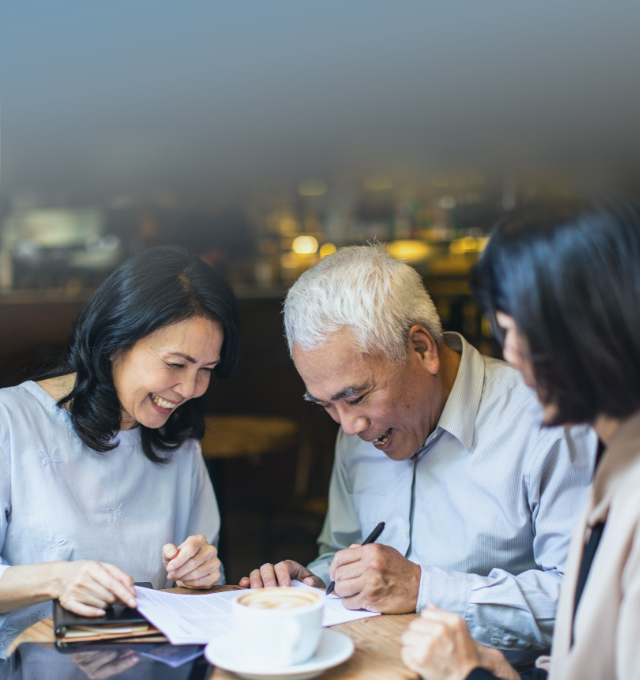 old asian guy is writing his will with wife